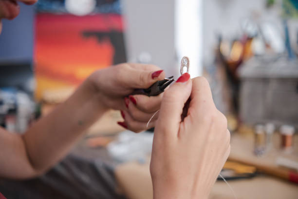 istock Making a DIY necklace from silver wire and crystal 1418955243