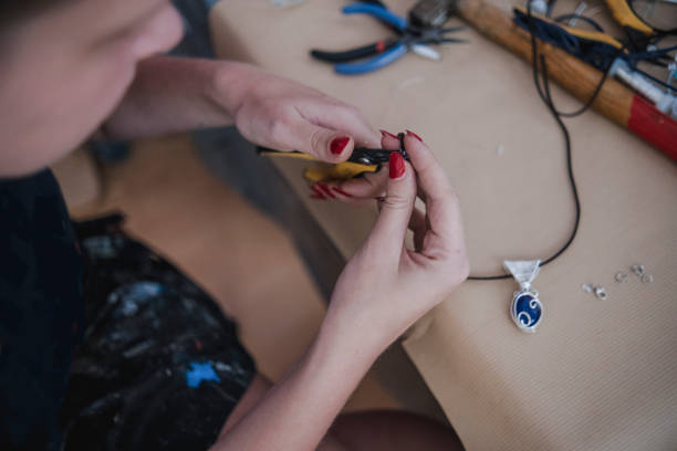 istock Making a DIY necklace from silver wire and crystal 1418955369