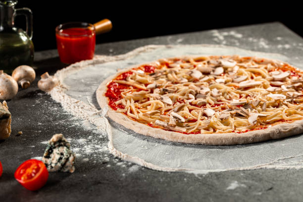 istock Semi finished pizza with cheese and tomato sauce 1418961523