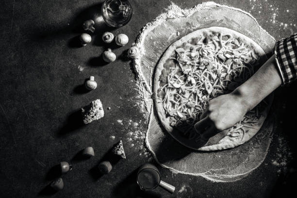 istock Making a pizza laying out the ham on the dough 1418961553