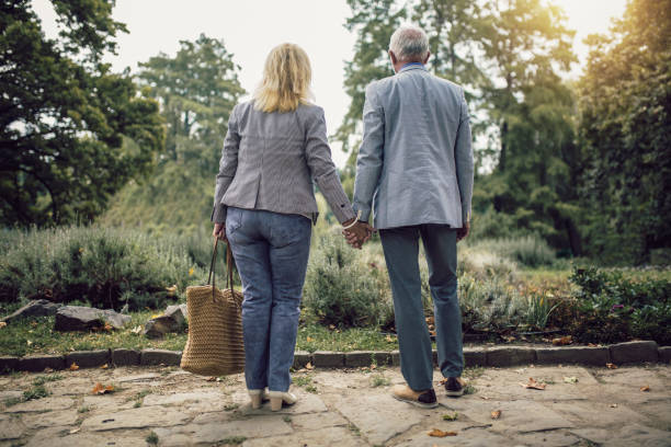 istock Elderly couple walking in park on sunny day 1418963101