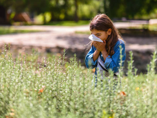 istock Girl with allergy blowing nose 1418965761