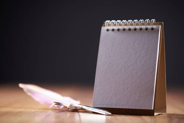 blank desktop calendar on wooden table top