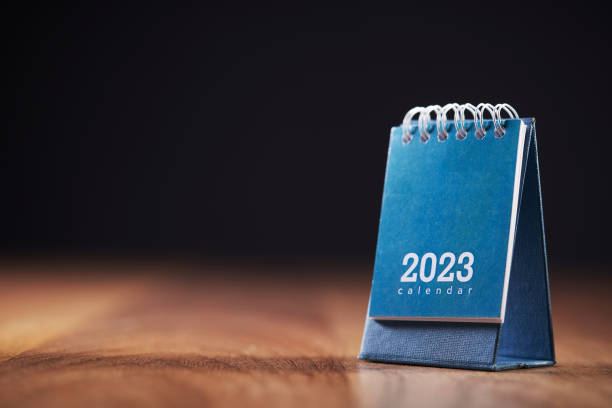 istock 2023 desktop calendar on wooden table top 1418965849