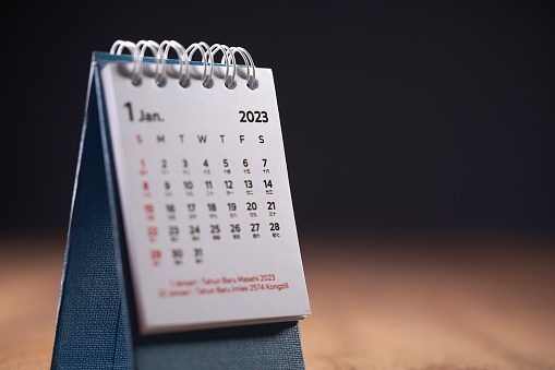 January 2023 desktop calendar on wooden table top
