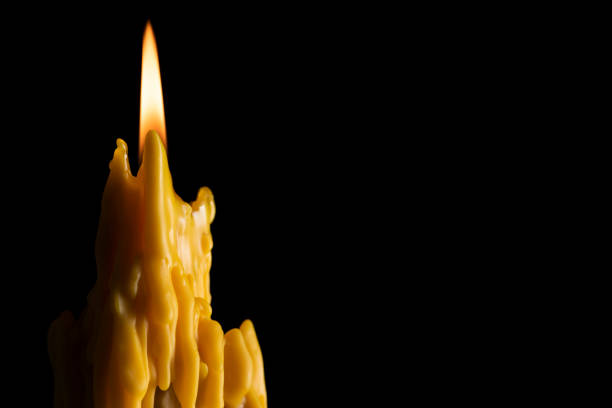 Candle flame melting wax to create dramatic and unique patterns and textures orange Buddhist candles Thailand Asia