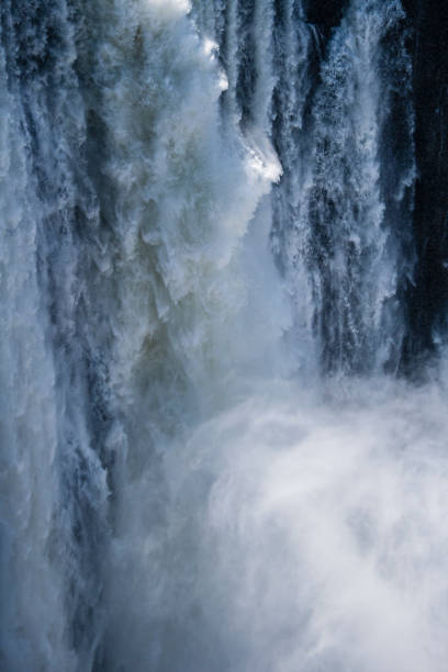 istock strong foaming waters of a waterfall 1418969804