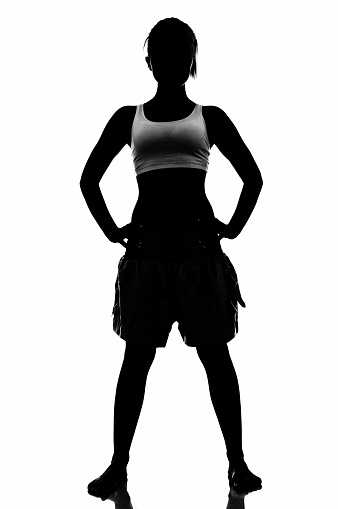 Silhouette ofyoung  womanwith hands on hip on white background