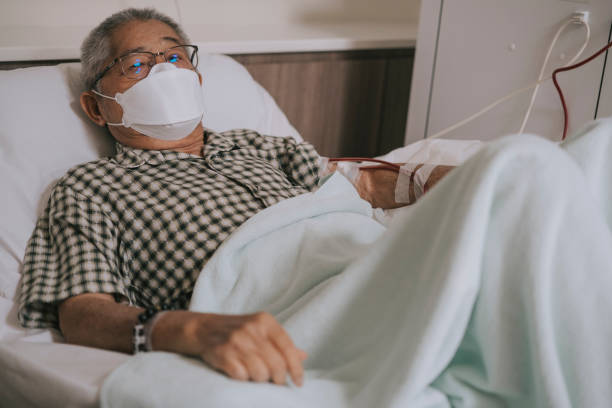 Asian chinese senior man in wheelchair with face mask under dialysis treatment in hospital Asian chinese senior man in wheelchair with face mask under dialysis treatment in hospital dialysis stock pictures, royalty-free photos & images