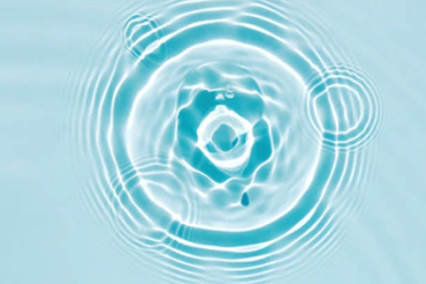 istock Defocus blurred transparent blue colored clear calm water surface texture with splashes and bubbles. Trendy abstract nature background. Water waves in sunlight with copy space. Blue watercolor shining 1418977264