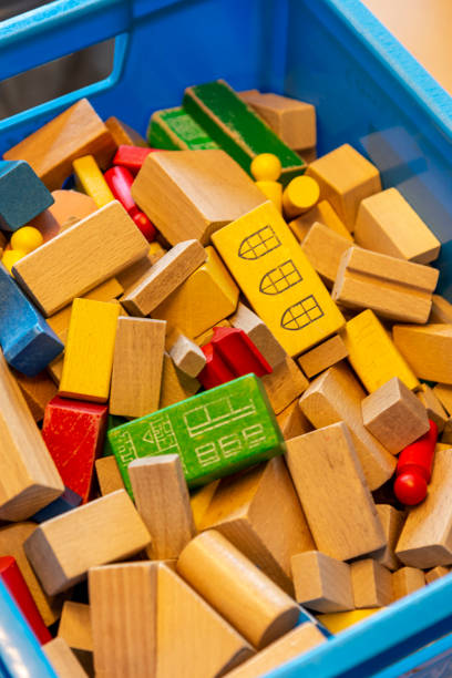 A white basket full of toys for kids to play.