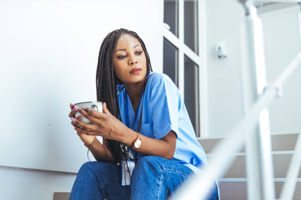 istock Female doctor drinking coffee on hospital background. 1418979762