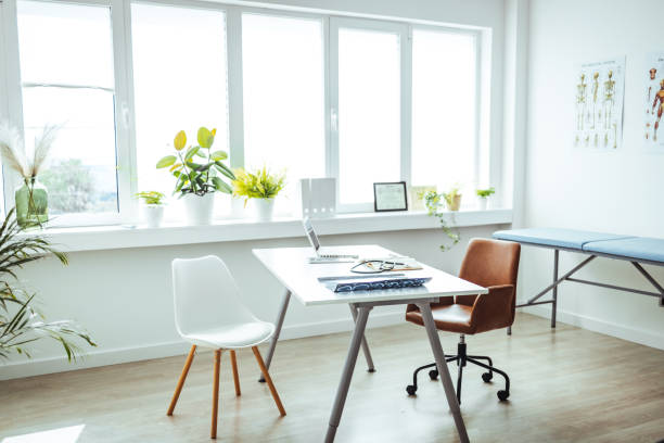 Doctor's office during the day Professional doctor's office interior with medical equipment, medicine and healthcare concept. Doctor's office during the day. Empty Doctor's Office medical examination room stock pictures, royalty-free photos & images