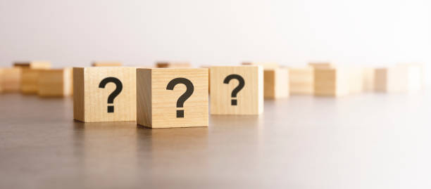 istock front view on many wood cubes with question marks. many question arising concept 1418984349
