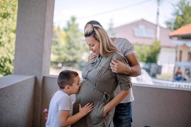 Happy family enjoying at home with mom pregnant