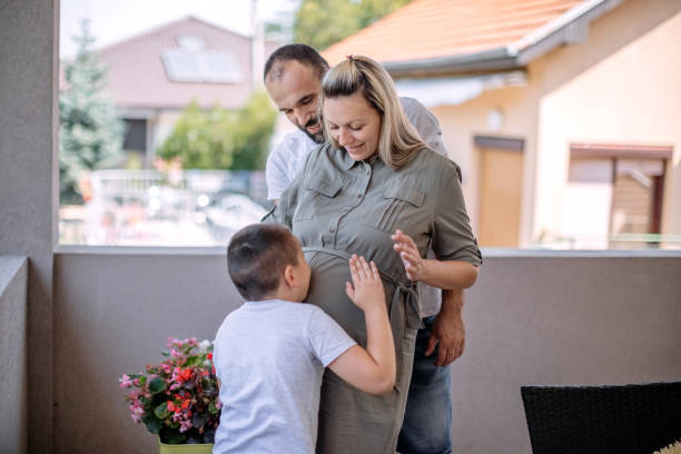 Happy family enjoying at home with mom pregnant