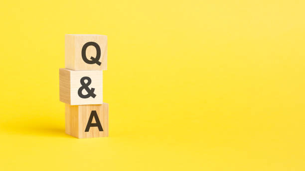istock Q A - Question and Answer - text on wooden block with yellow background. 1418992181