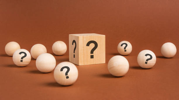 istock front view on many wood cubes and wood balls with question marks. many question arising concept 1418992205