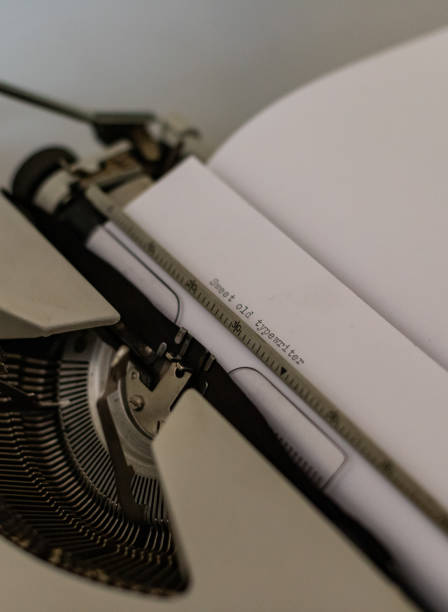 istock Old typewriter on the desk, close up of mans hands typing on the typewriter telling writing and telling a story. 1418992529