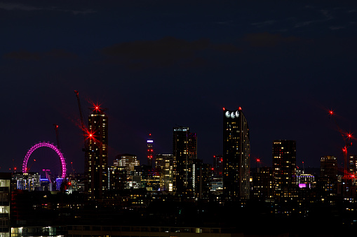 A scenic skyline view of the Elephant and Castle area, London Eye and BT Tower in the background after the sunset as seen from the South-East