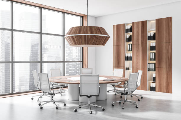 istock Light conference room interior with seats, table and shelf near panoramic window 1418996142