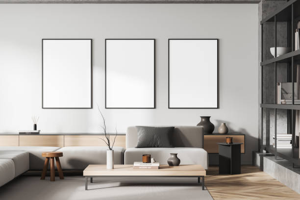 istock Light chill room interior with couch and decoration, shelf and mockup frames 1418998104
