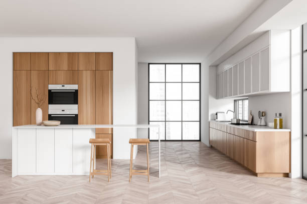 istock Light kitchen interior with island and seats, appliances and panoramic window 1418998552