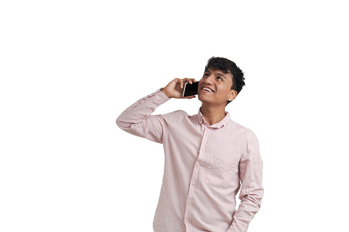 Young peruvian man smiling and speaking on the smartphone looking up. Isolated over white background.