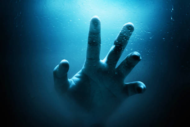 Human hand drowning, Halloween theme stock photo