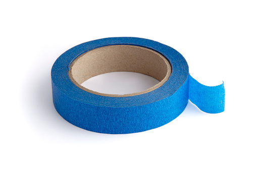 Close up of three rolls of transparent package adhesive tape stacked on top of each other and side by side on white background