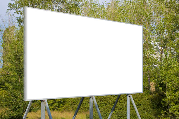 istock Blank advertising signboard with trees on background - concept with copy space for text inserting 1419009808