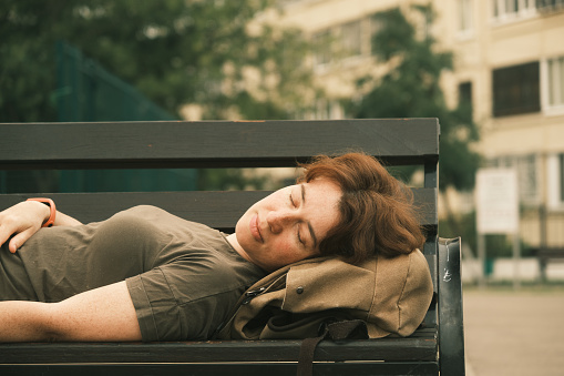 Woman is sleeping on the bench