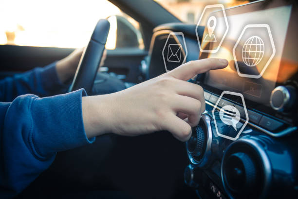 istock Drive a car and use smartphone. Reading messages holding a cell phone while driving. Transportation and new automotive technology concept. Infotainment, navigation, multimedia communication device 1419011413