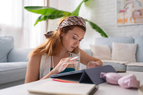 istock Young female freelance graphic designer working on digital tablet from her home 1419011476