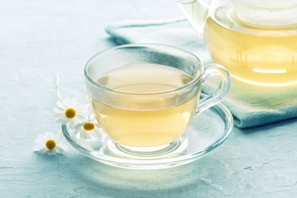 istock Chamomile tea. Camomile infusion in a cup with a tea pot 1419011500