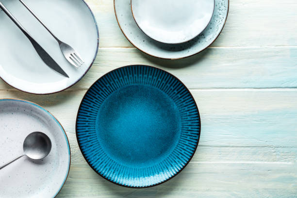 istock Modern tableware set with a vibrant blue plate and cutlery, overhead shot 1419011534