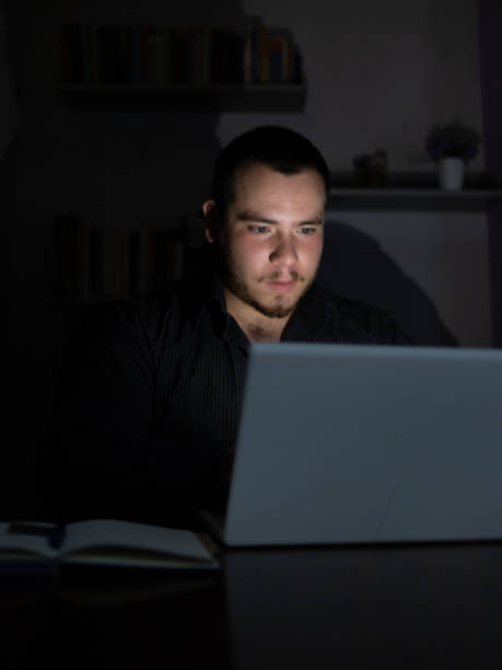 istock Young man at night working on his laptop finishing his work. 1419014214