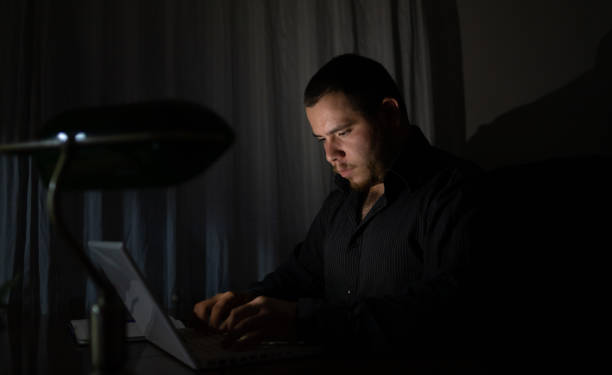istock Young man at night working on his laptop finishing his work. 1419014221