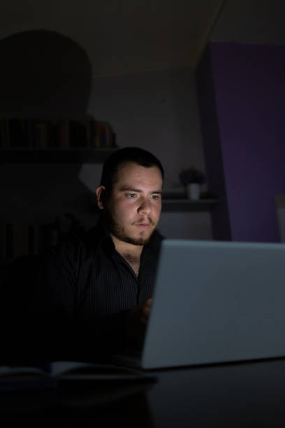 istock Young man at night working on his laptop finishing his work. 1419014222