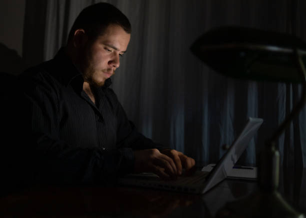 istock Young man at night working on his laptop finishing his work. 1419014245