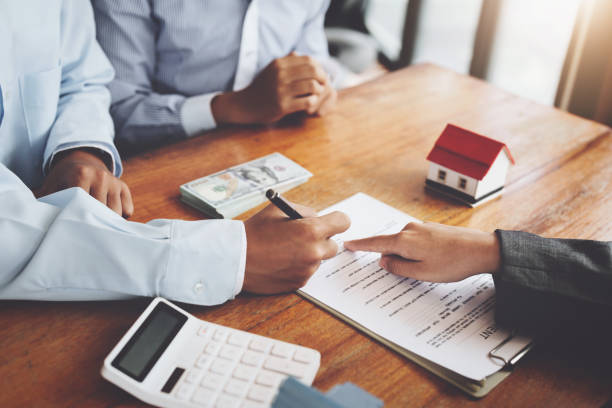 istock A couple is reading a home purchase contract before signing documents with a real estate agent 1419016242