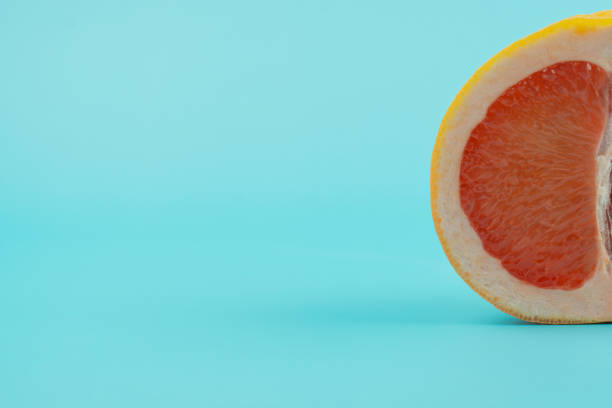 istock half of a cut grapefruit on a blue background 1419017493