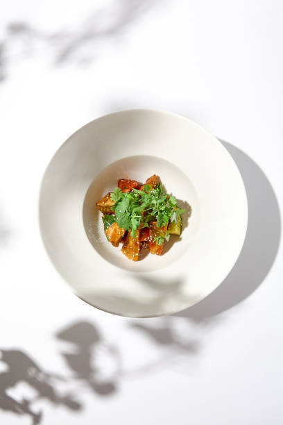 istock Crispy eggplant in chinese style on white plate. Crispy eggplant salad on summer menu. Asian appetizer - roasted aubergine with coriander leaves. Vegan food. Aesthetic veggie menu. 1419017781