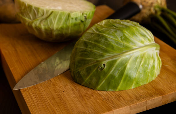 istock white cabbage close up on wooden board at kitchen table 1419018514