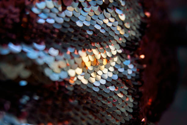 istock Glamorous background of multi-colored sequins, sequins. Sequins on the fabric, selective selective soft focus. Sequins shimmer in the sun 1419018555