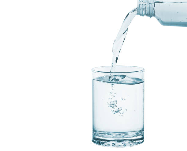 istock Pouring water from bottle into glass isolated 1419020051