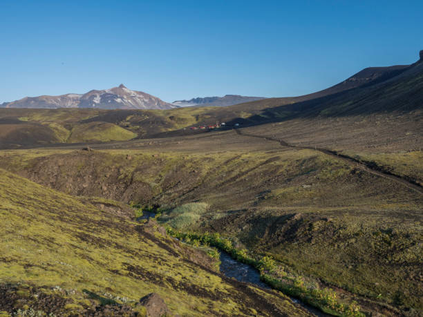 istock Icelandic landscape with blue river stream Botnar mountain hut at Iceland on Laugavegur hiking trail, green valley in volcanic landscape among lava fields. Early morning, summer blue sky 1419022104