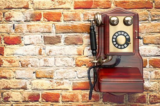 Retro Phone on grunge brick wall background. Vintage Telephone isolated 3d render