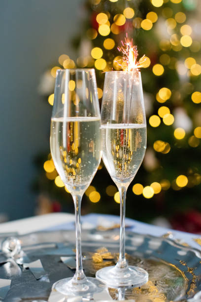 istock Glasses with champagne near Christmas tree 1419022516