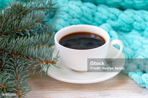 A Cup Of Coffee A Plaid And A Christmas Tree Branch Stock Photo - Download Image Now